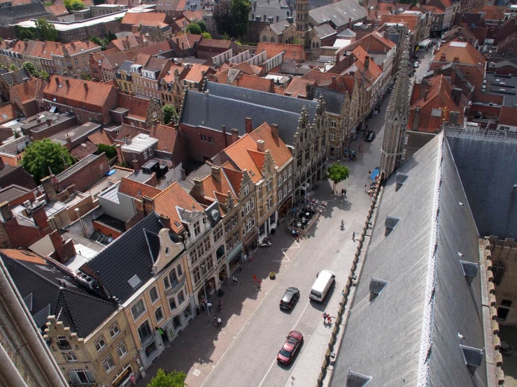 a wide aerial s of a city with a bus and cars driving down the street