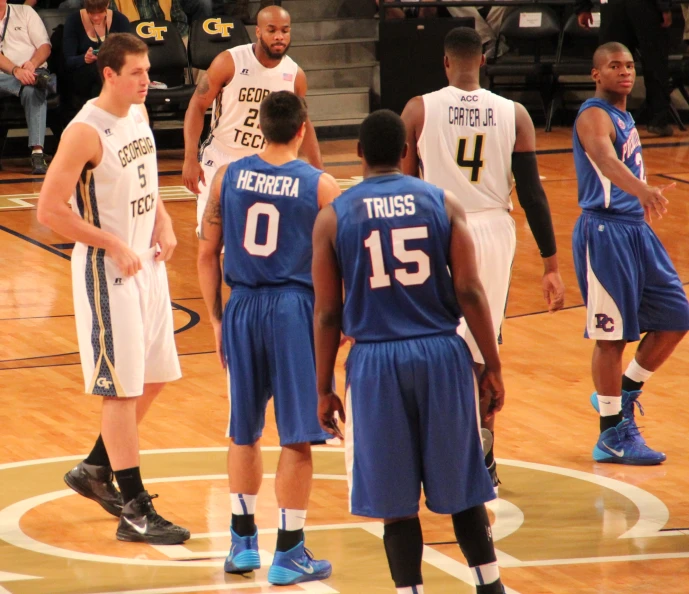 the men are playing basketball in the court