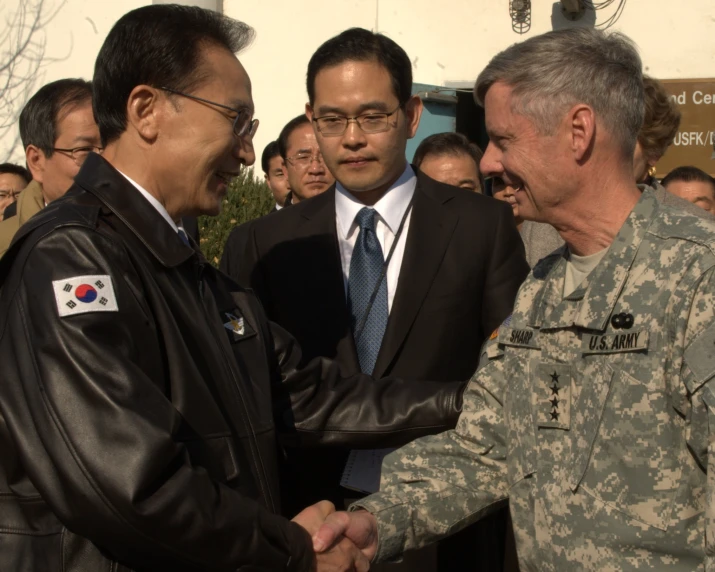 two military men shaking hands near each other