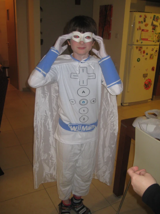 a child wearing a white costume standing on the ground