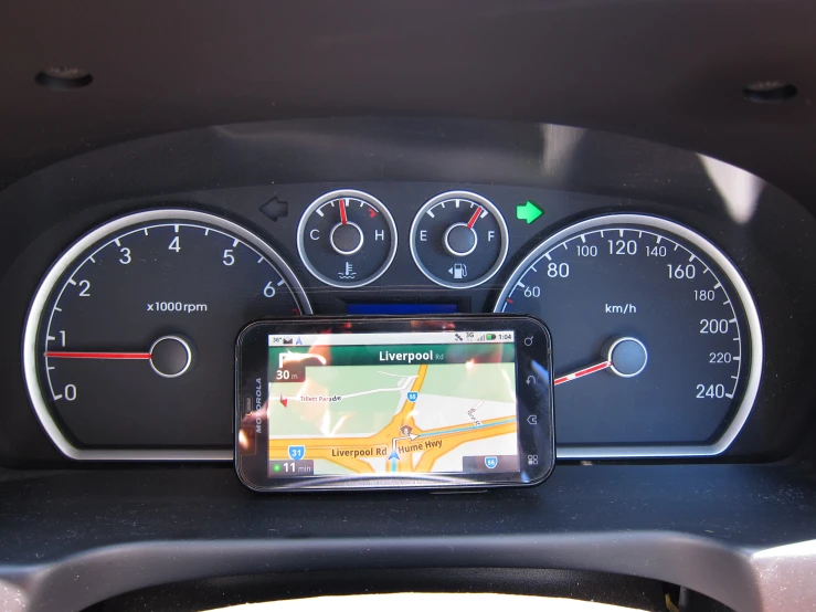 a car dashboard showing gps, meters, and maps