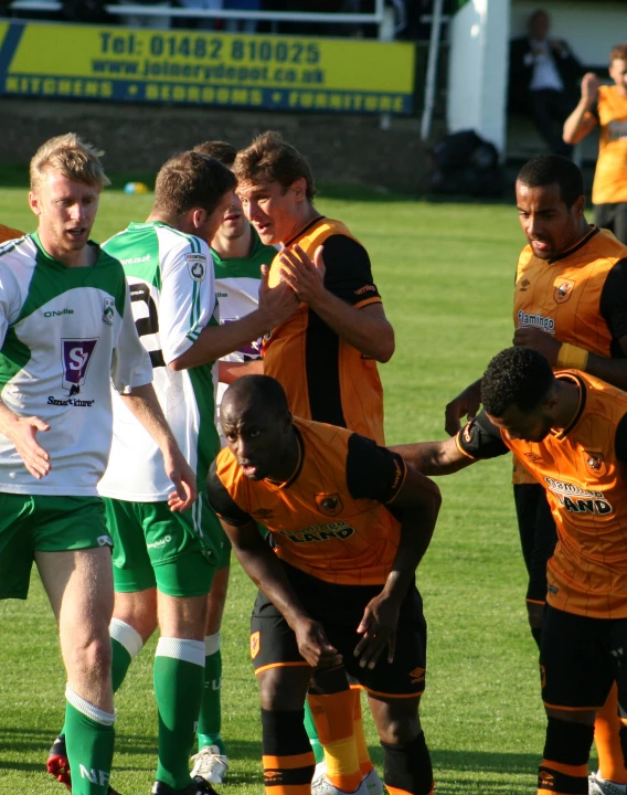 young men compete for a soccer ball in the park