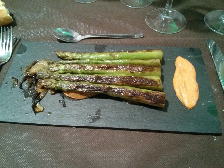 a large piece of cooked asparagus with bread and er