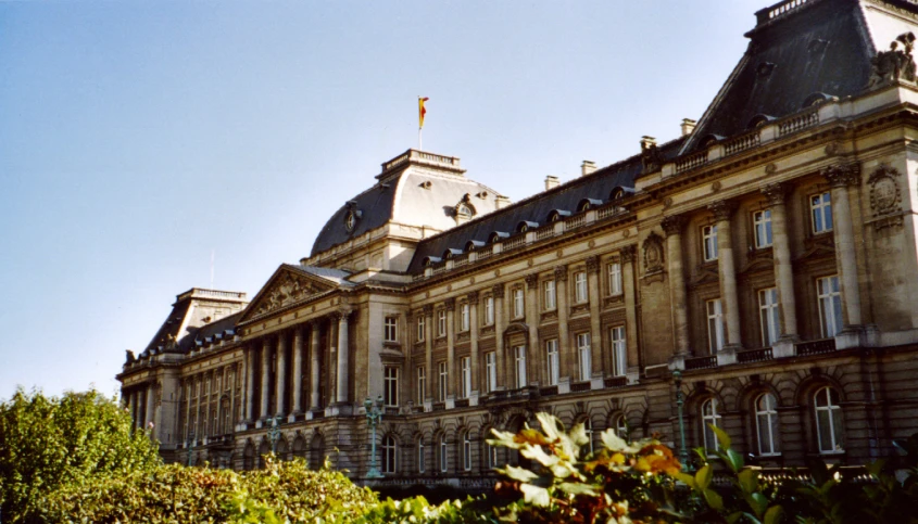 an old building with a clock tower and sky in the background