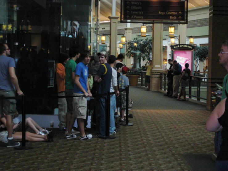 several people standing in line at a mall