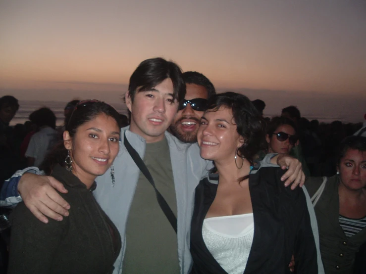 group of people posing for po at sunset