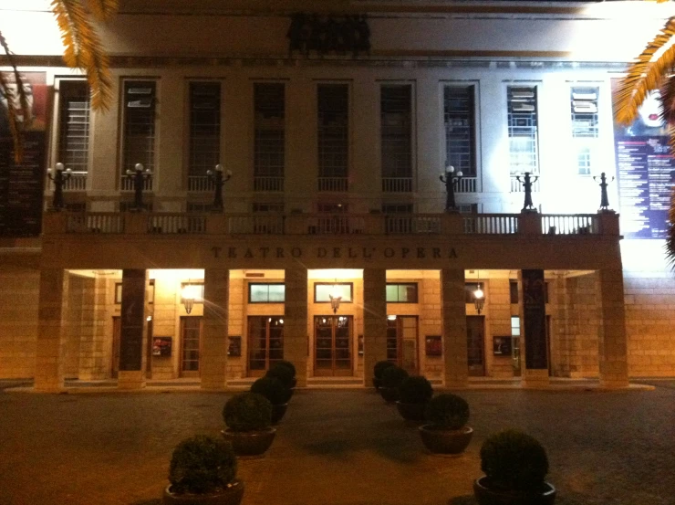 a building with plants outside it at night