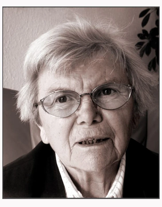 an elderly woman with glasses on her face