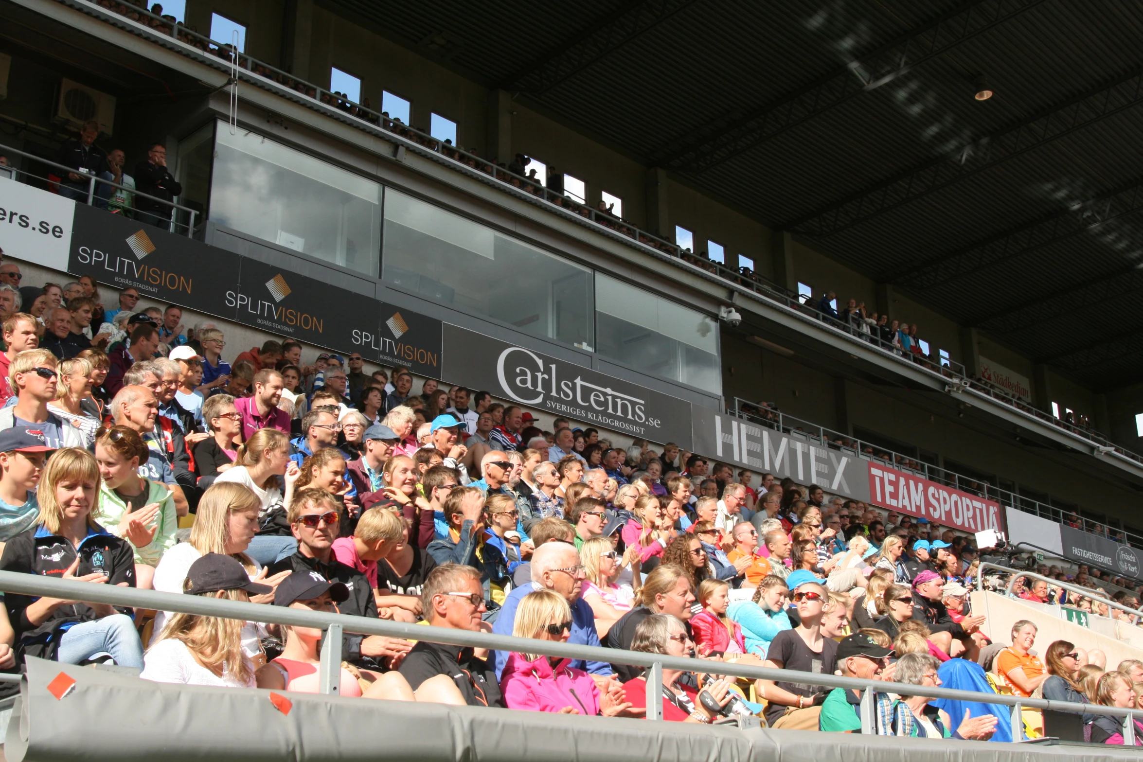 a crowd of people sitting in a stadium