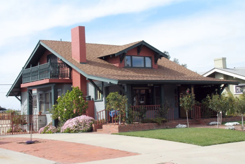 a house with flowers in the front yard