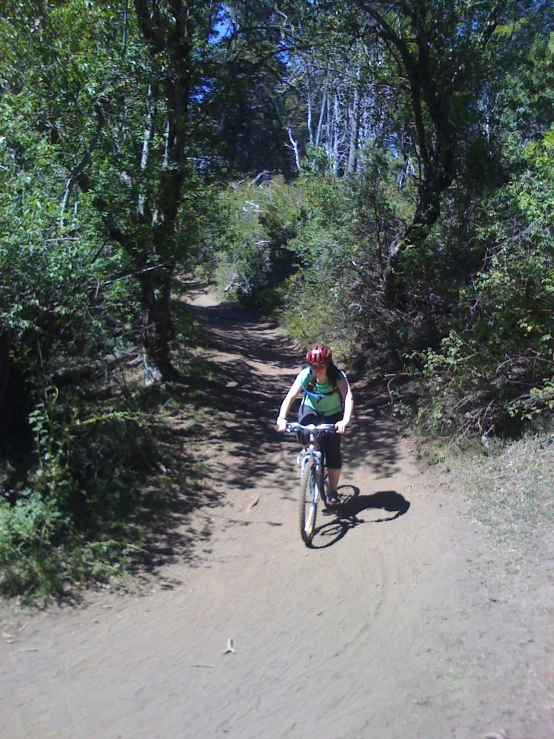 the woman is riding her bike in the woods