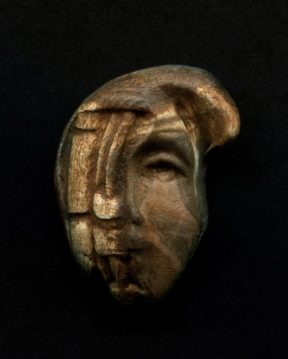 an ancient wooden carving of a woman
