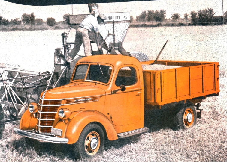 an orange truck is parked next to a metal pole