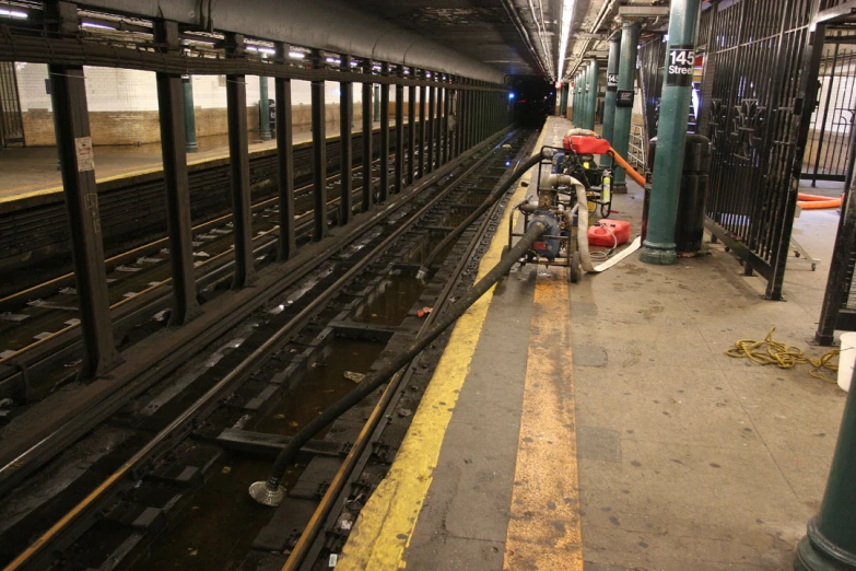 an empty platform next to a train with lots of carts