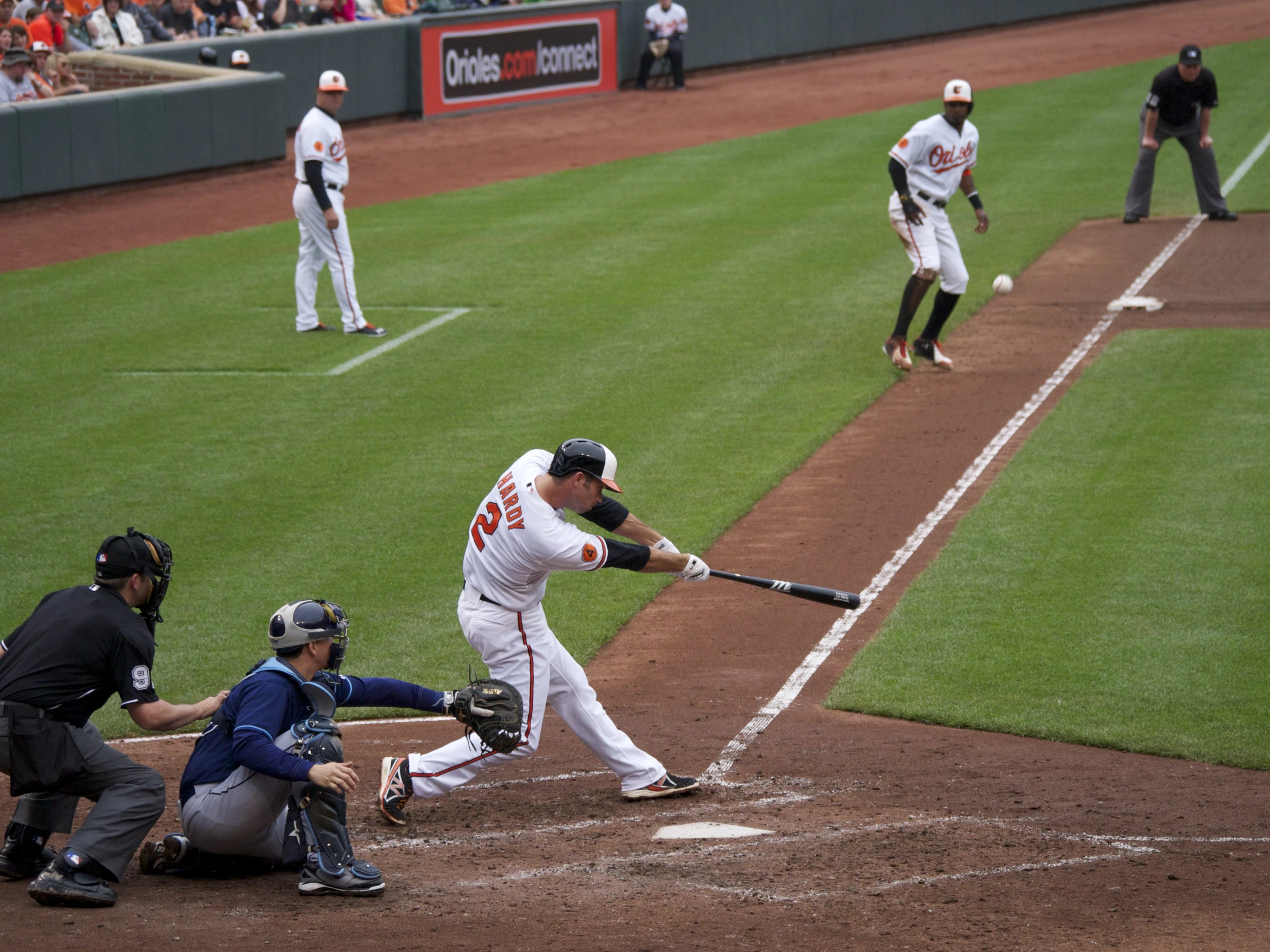 a baseball player hitting a ball with a bat