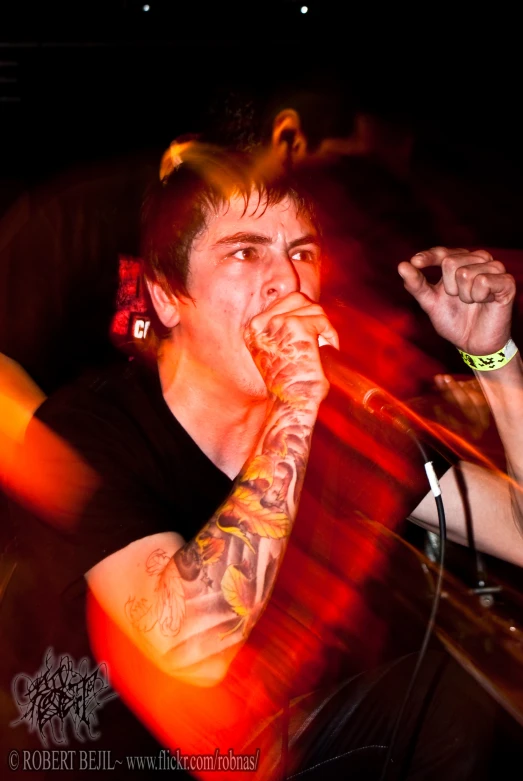 a man is sitting on a stage while playing the trumpet