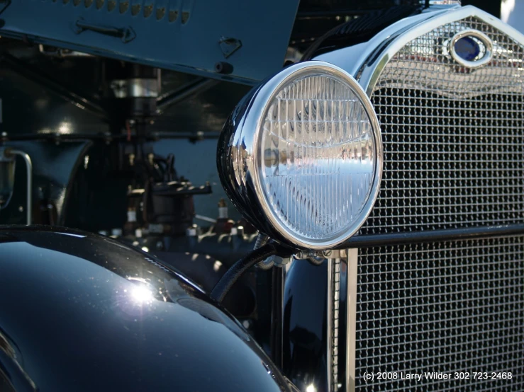 closeup of an old fashioned car with a grill grill
