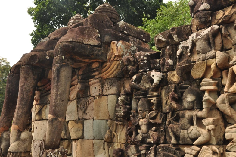 statues with a small statue of an animal hanging off the side