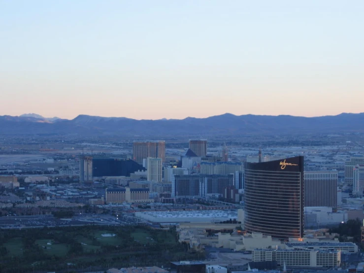 a city with buildings and mountains in the distance