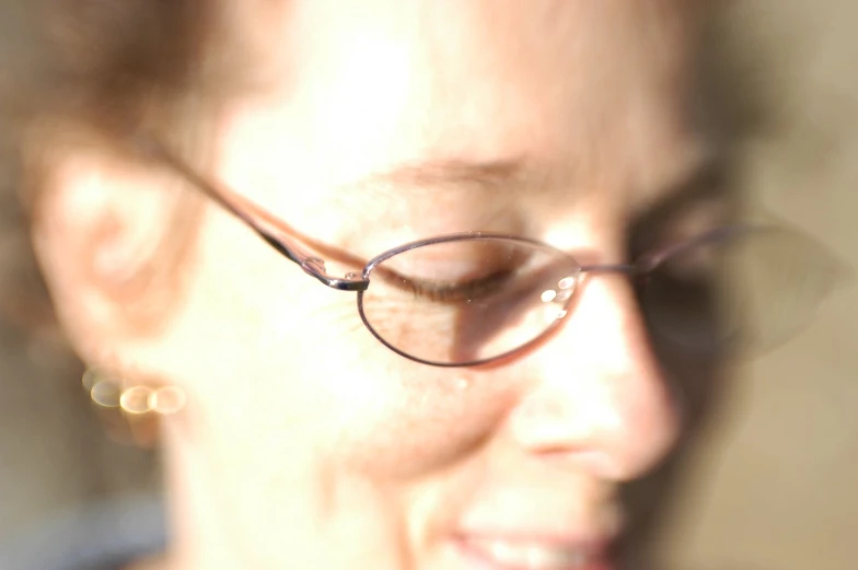 a woman with glasses wearing a ring on her thumb