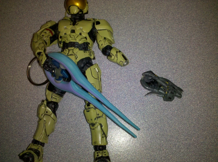a sci fie with yellow and blue armor and a plastic toy insect