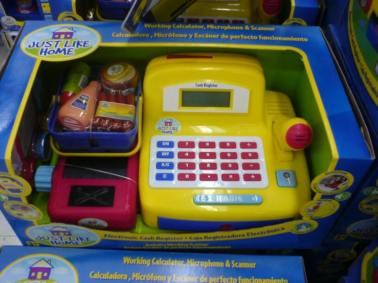 a bright yellow toy calculator set with two different toys