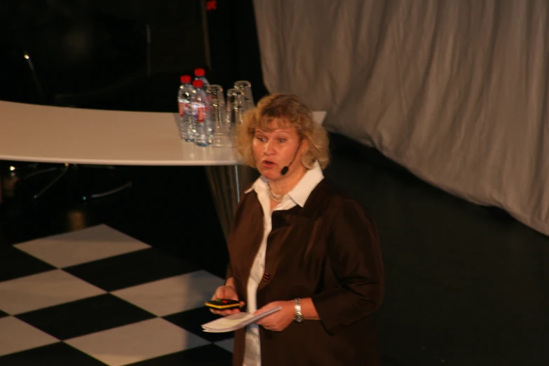 a woman in brown is talking on the phone