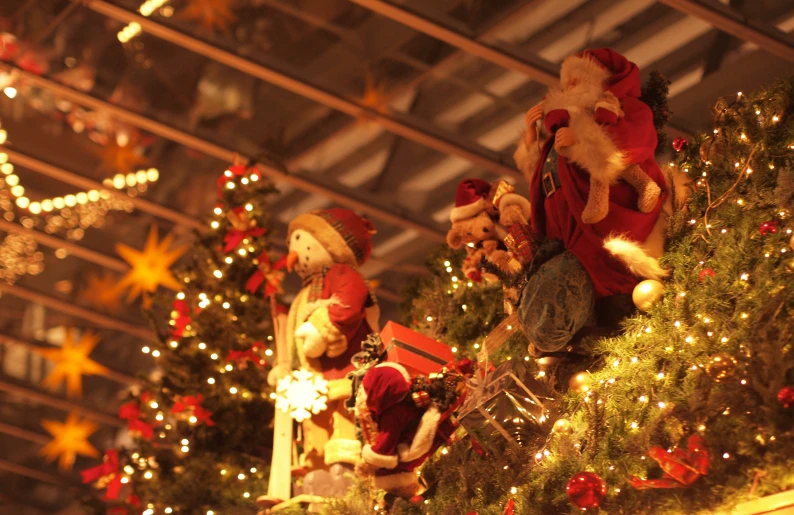 a large collection of christmas trees are covered in stuffed toys