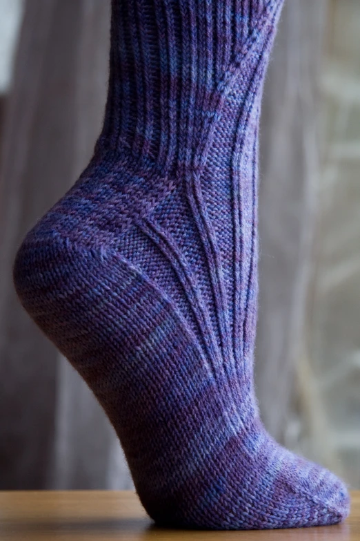 a close up po of a persons foot showing their purple socks