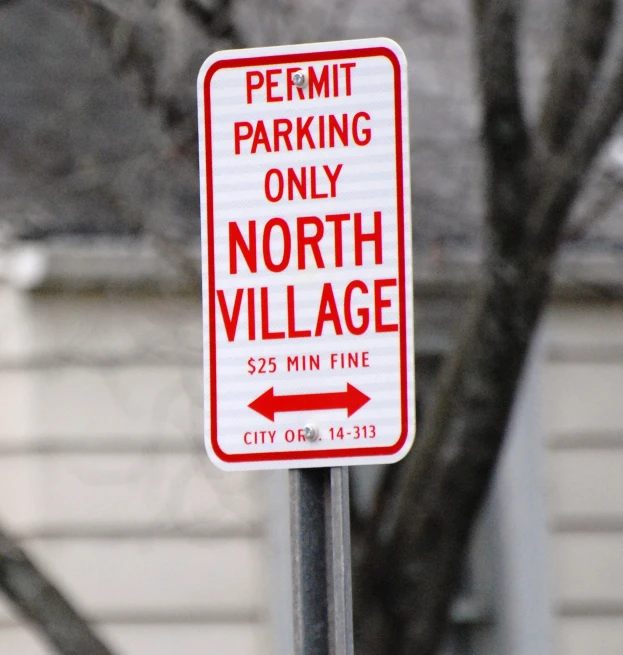 there is a red sign with the word permitt parking only