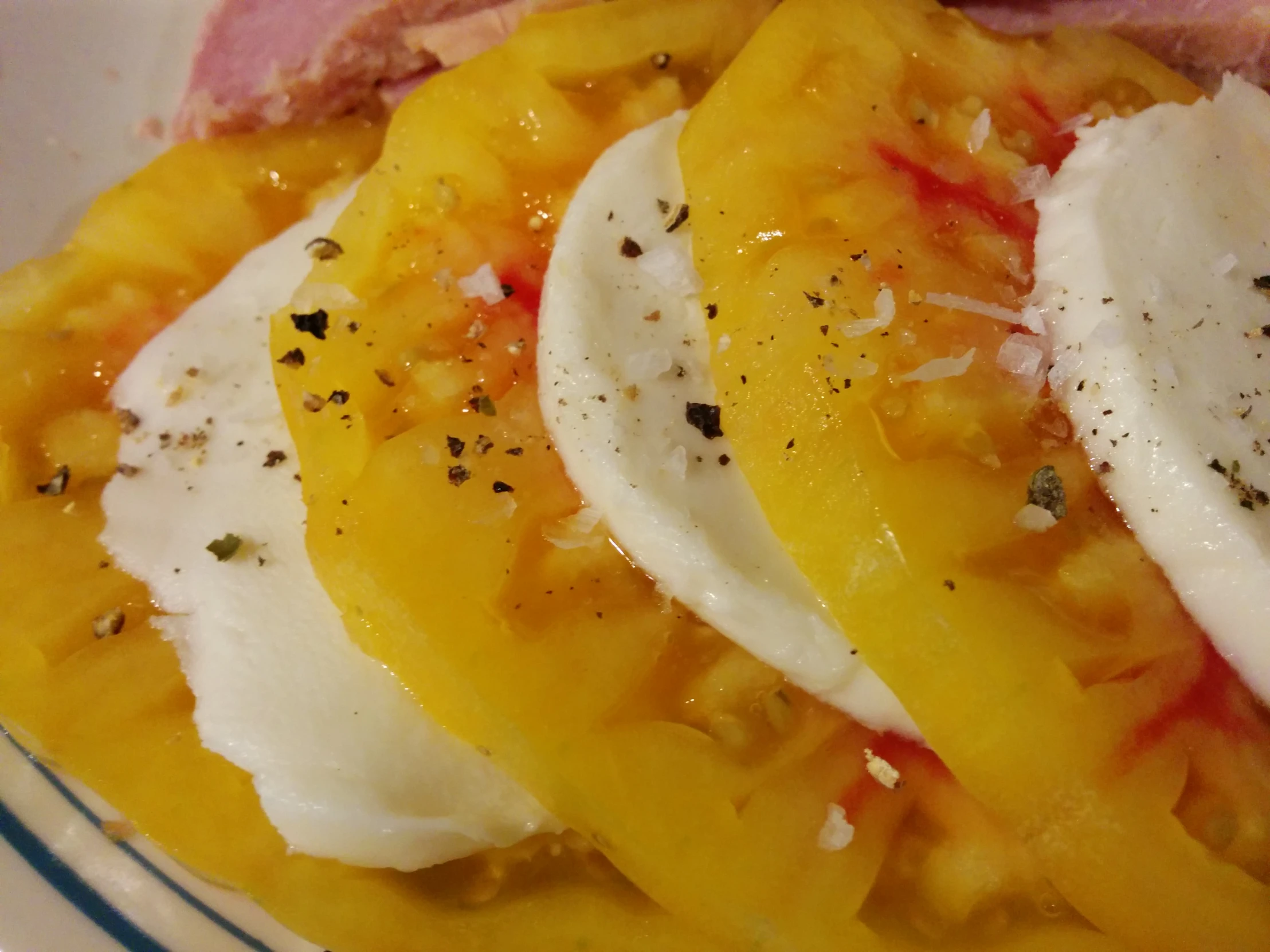 a white plate topped with sliced yellow peppers