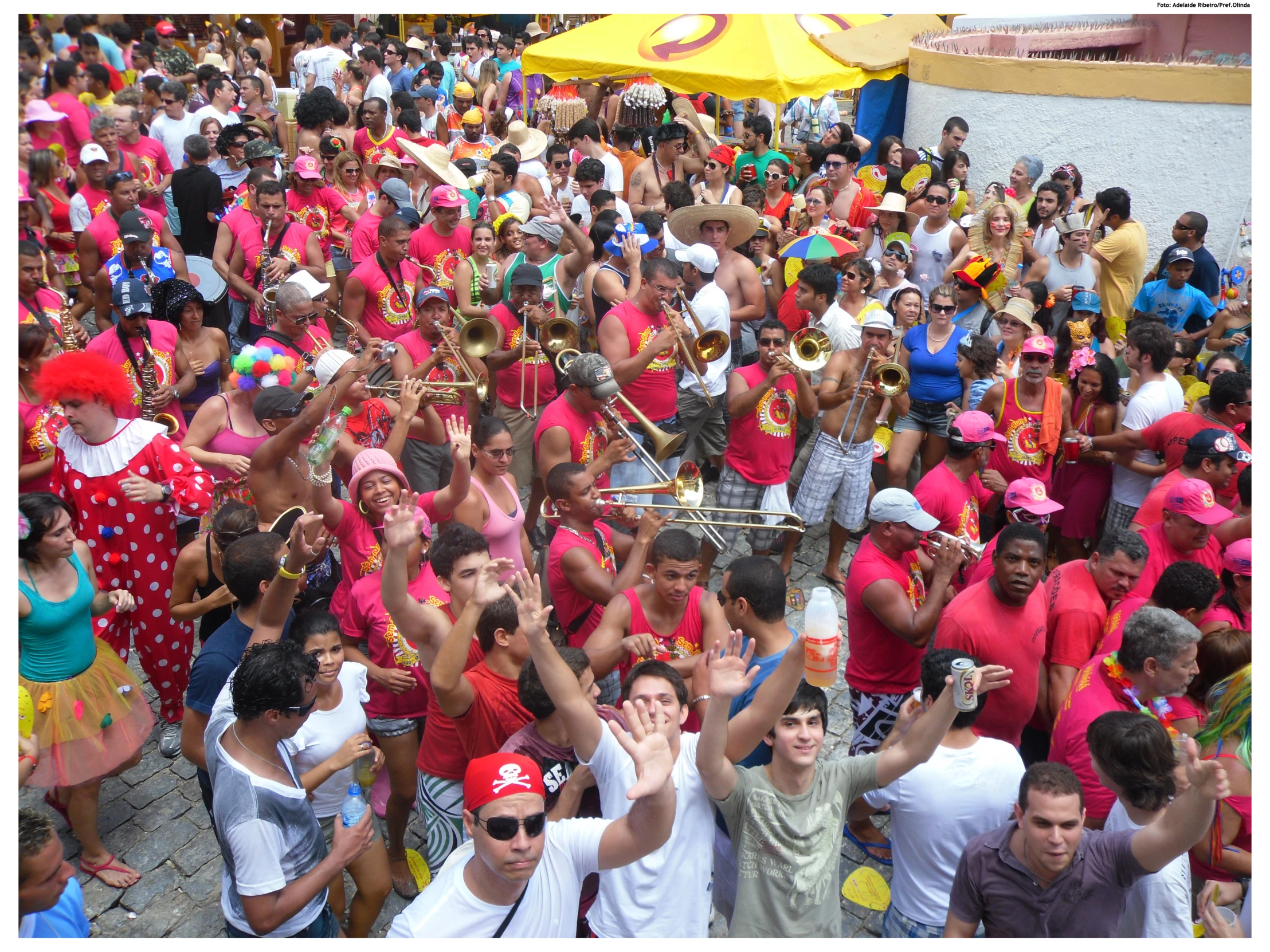 people at a festival cheering, and one man raising his hands in the air