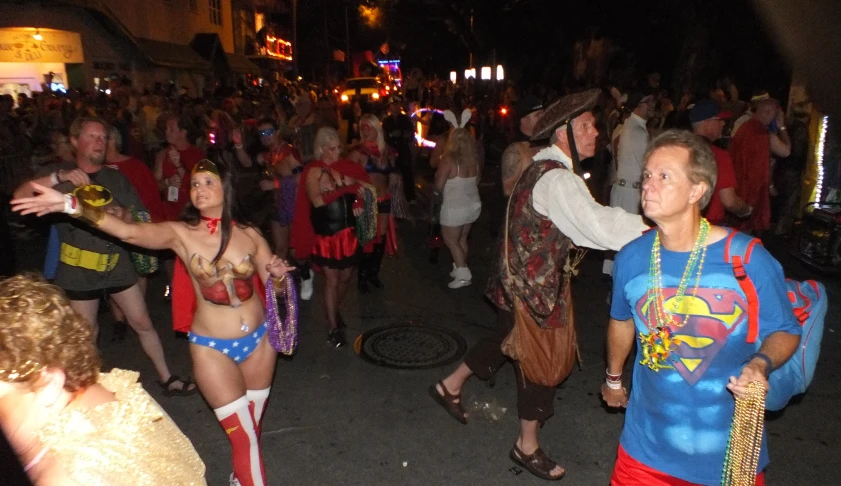 people in costumes dancing on the street at night