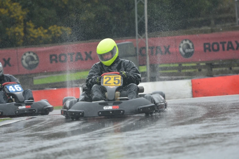 two men on small boats racing on the wet street