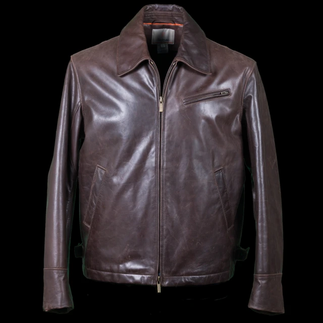 an brown leather jacket on a black background