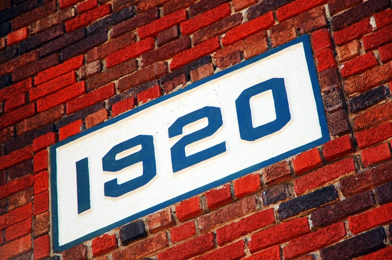 there is a close up view of a sign on the brick wall