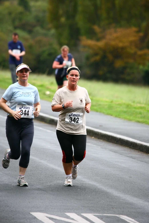 people are running on the street during a marathon