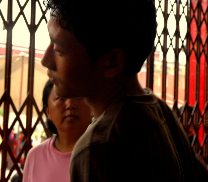 a group of people sitting in front of a gate