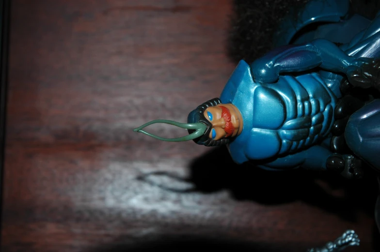 a blue figurine with two teeth and some arms