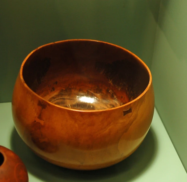 a bowl that is on the table with other objects