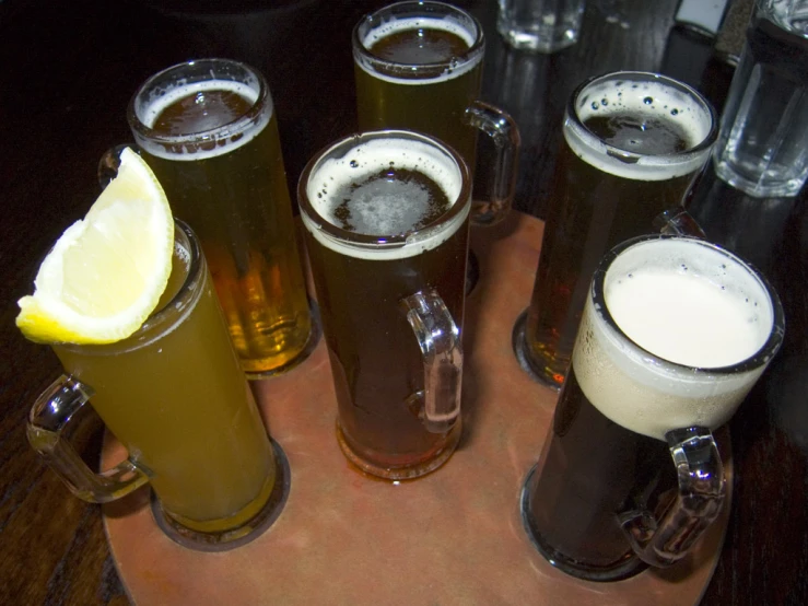 four different types of beer are arranged on the table