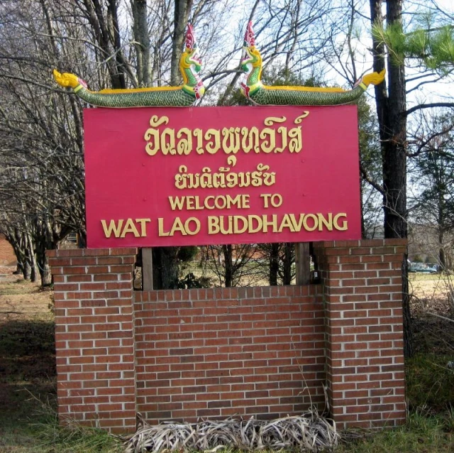an oriental welcome sign with brick walls in the foreground