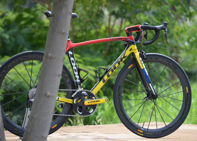 a yellow bike with blue and red on a ramp