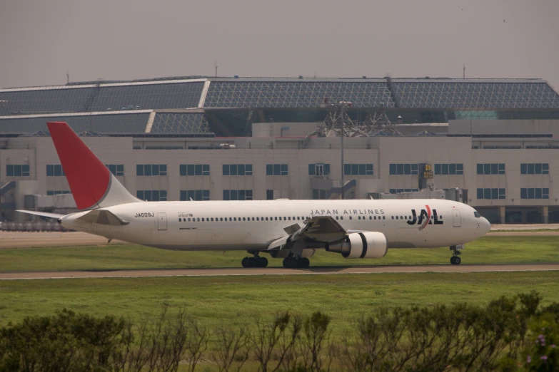 a passenger jet is landing on an airport runway