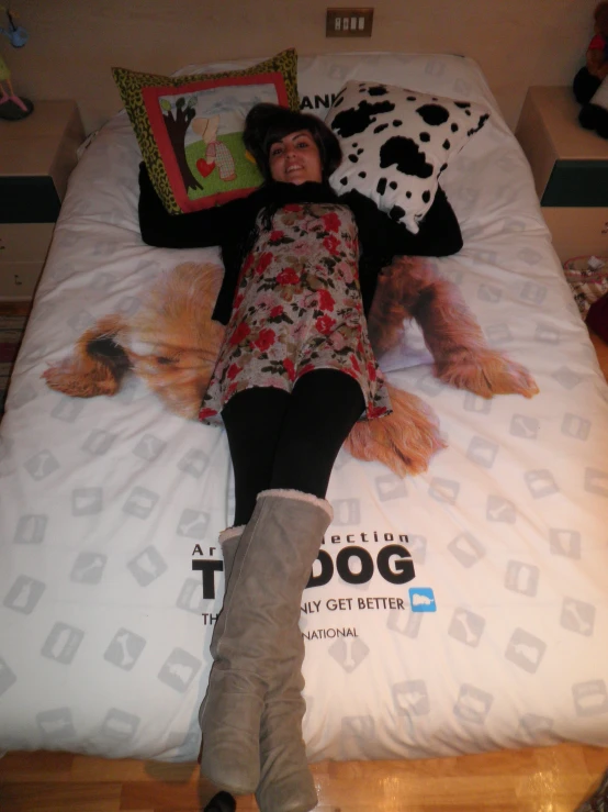 a woman laying on top of a bed with pillows