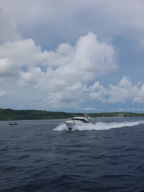 a boat is speeding across the water in the ocean