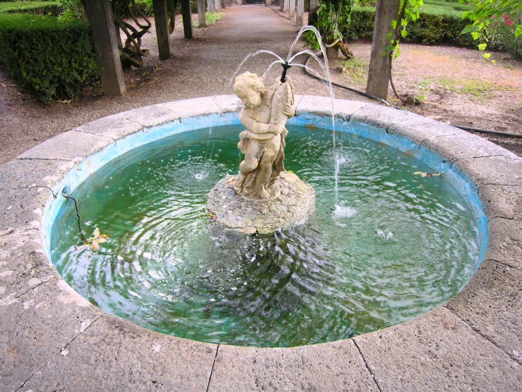 a statue is shown with a fountain in front