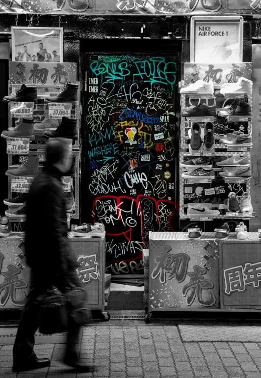 black and white pograph of the front of a graffiti covered building