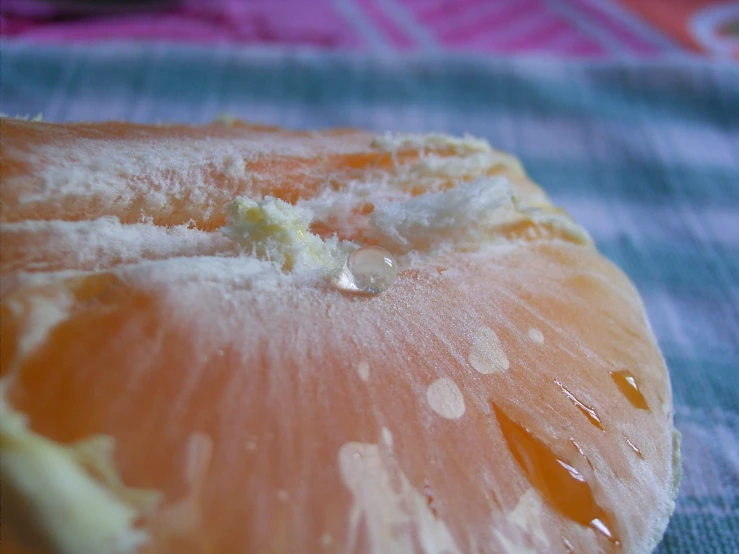 an orange peeled into pieces on a table