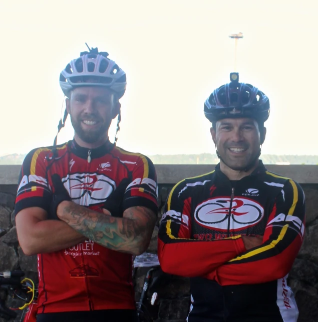 two men in bikes uniforms standing next to each other